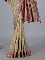 Cream shimmer tissue silk saree with festive border