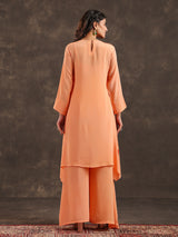 Light peach yoke style palazzo suit with festive embellishments