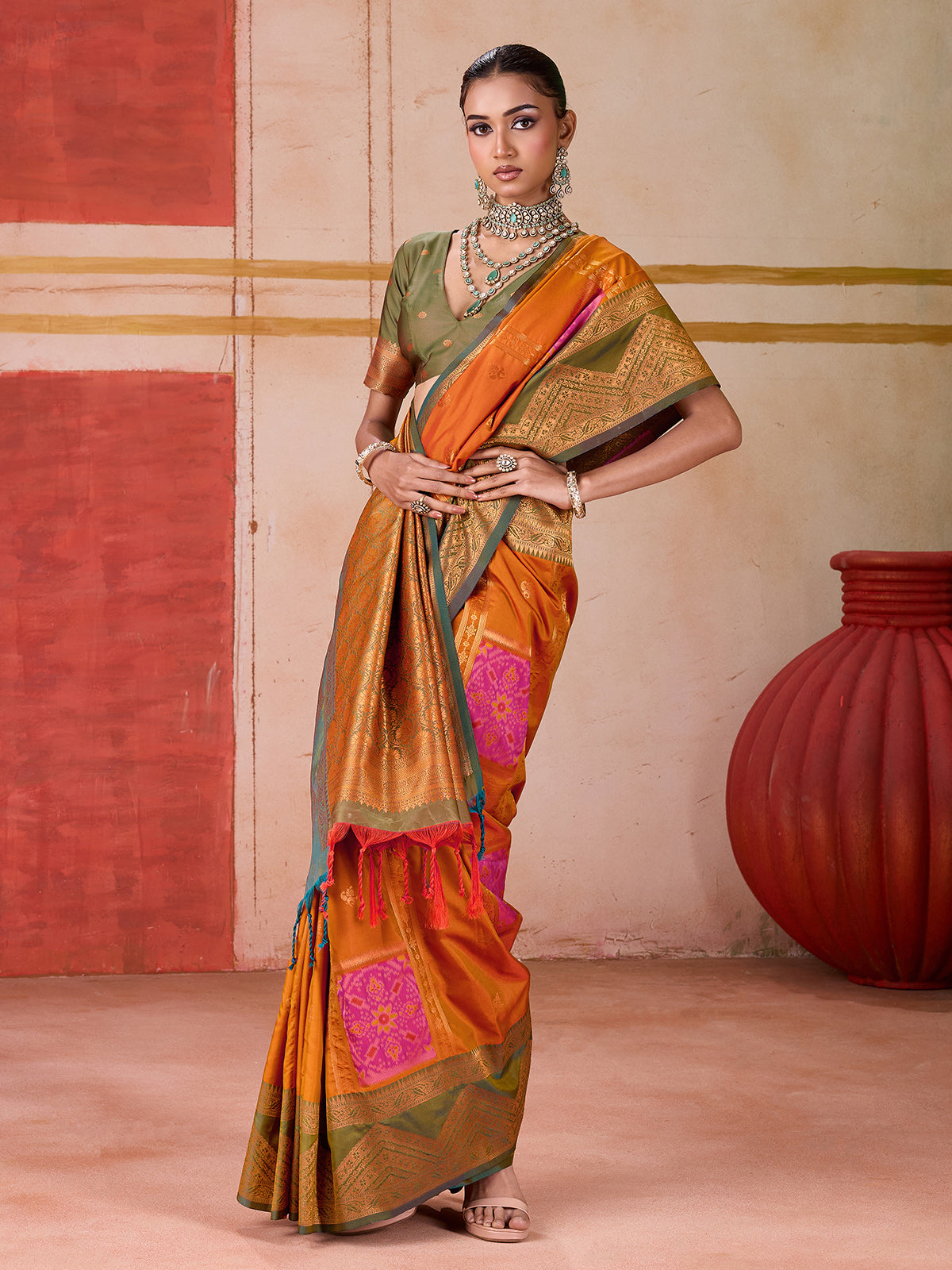 Orange silk saree with bold green border