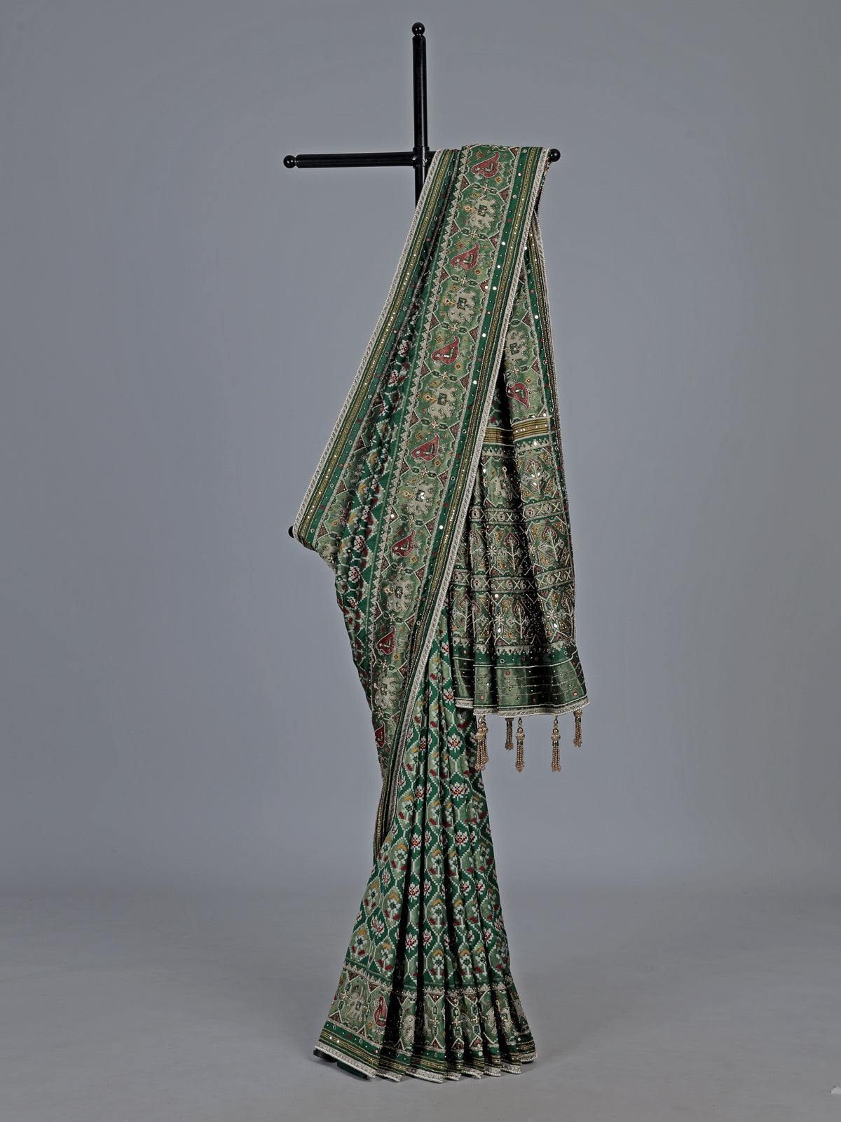 Green art patola silk saree with sequins and zardosi accents