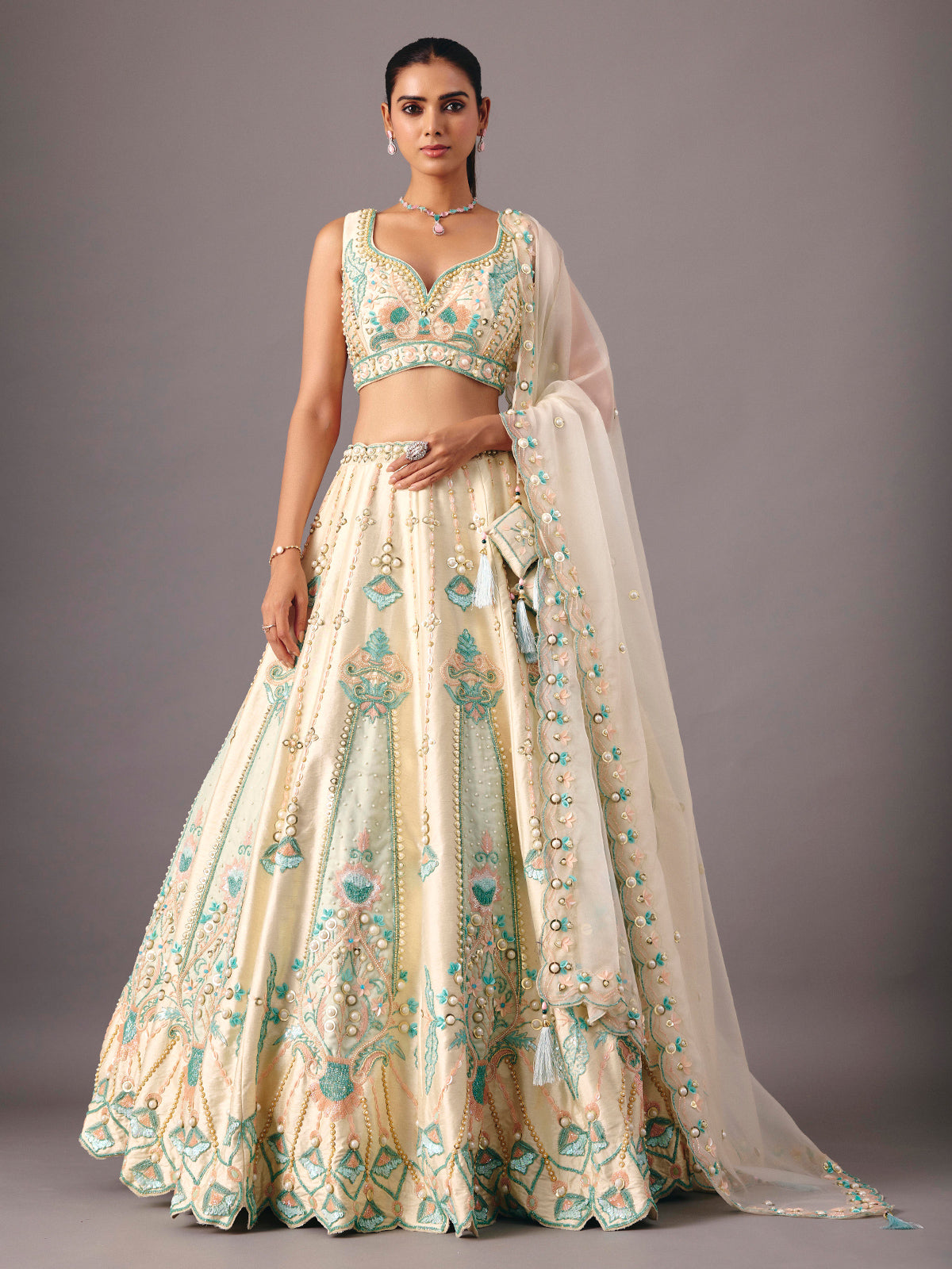 Cream silk lehenga choli with pearl and thread detailing
