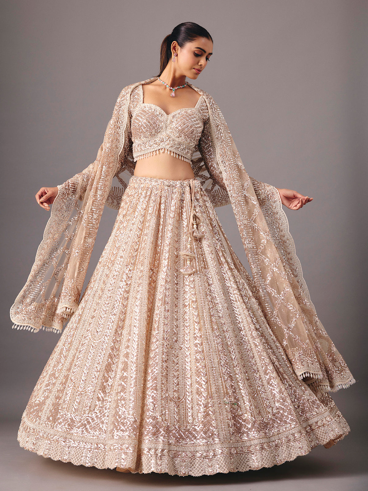 Beige net lehenga choli with pearl and sequin detailing