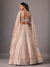 Beige net lehenga choli with pearl and sequin detailing