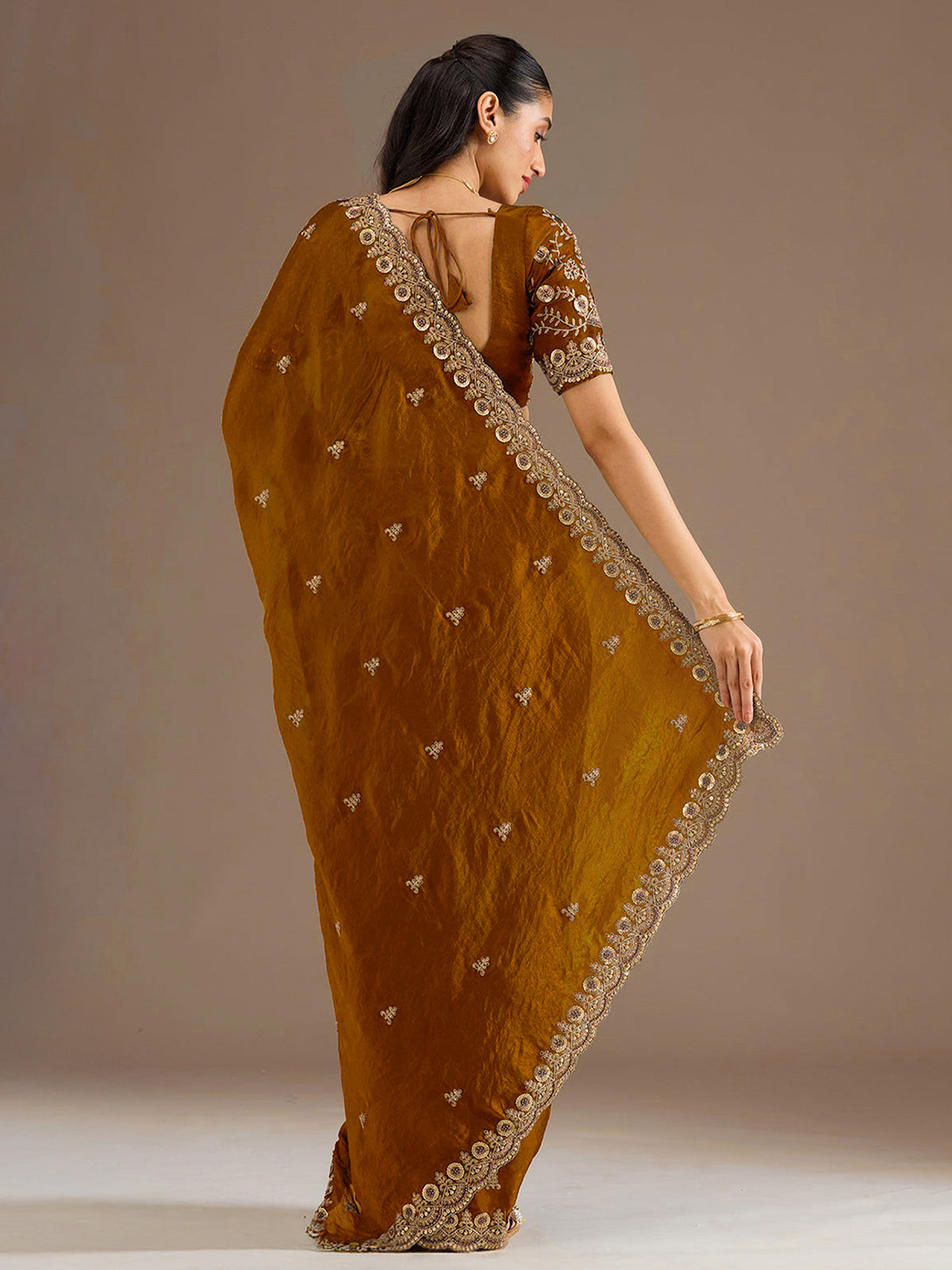 Gold tissue saree with cutdana and sequins work