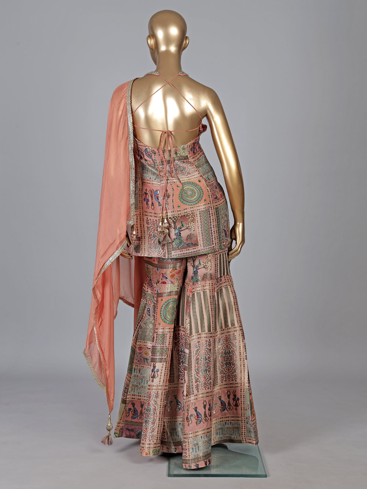 Pastel peach silk sharara suit with rich embellishment