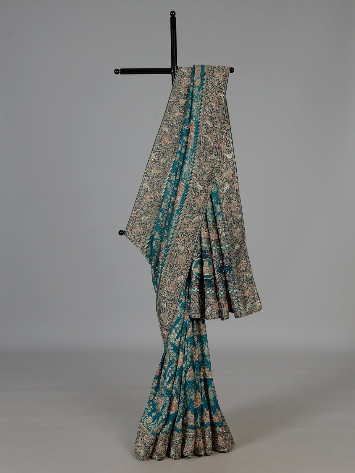 Teal green dola silk saree with royal motifs