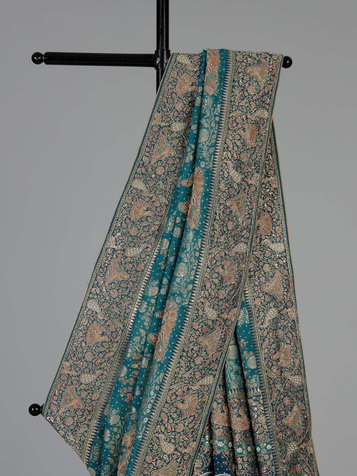 Teal green dola silk saree with royal motifs