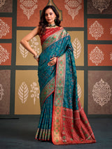 Opulent teal blue zari woven patola silk saree with contrast red blouse