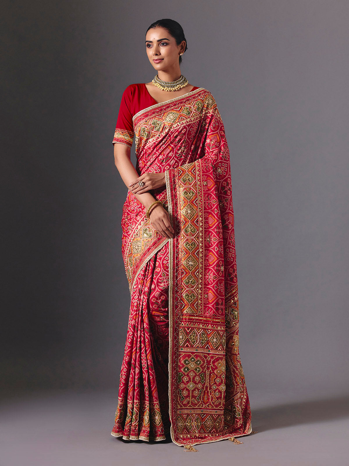 Rani pink art silk patola saree with festive handcrafted embellishments