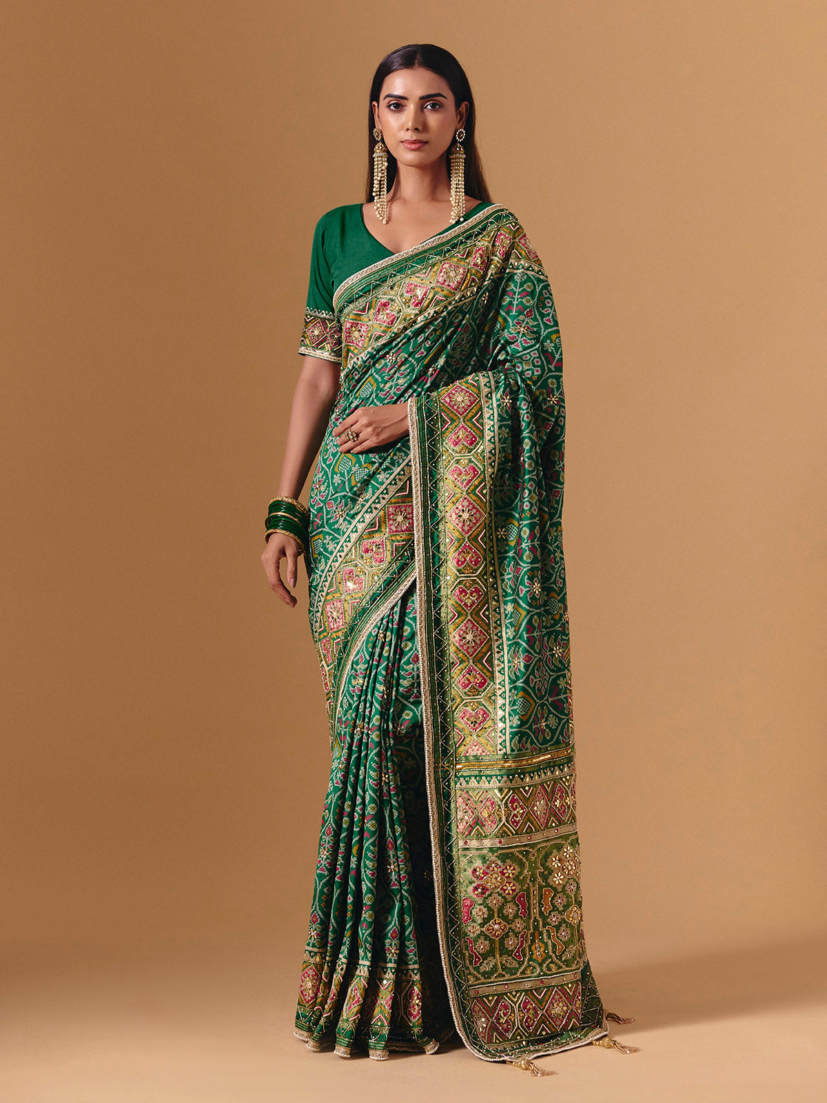 Green art silk patola print saree with timeless festive elegance