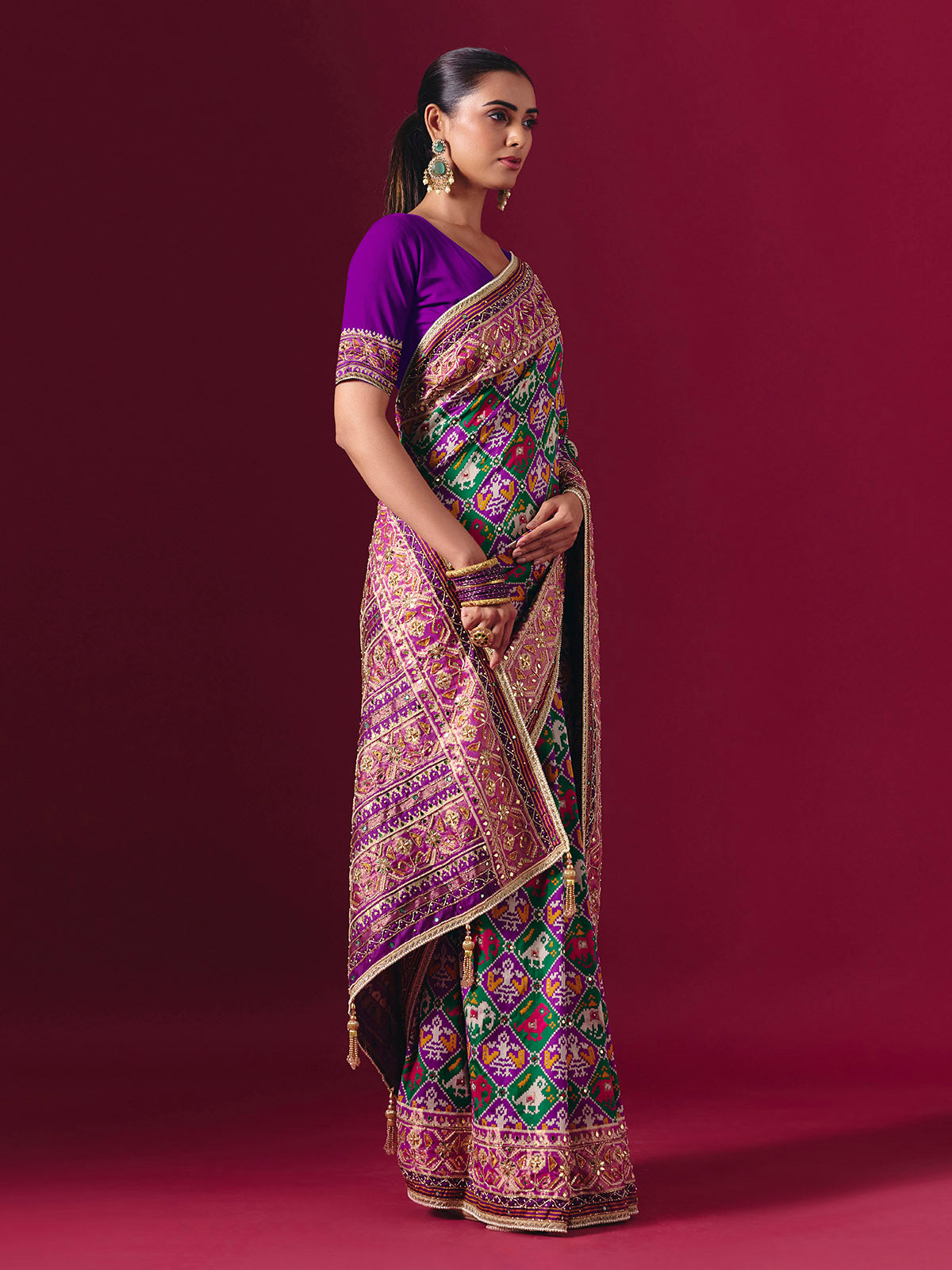 Purple and green art patola silk saree with festive motifs