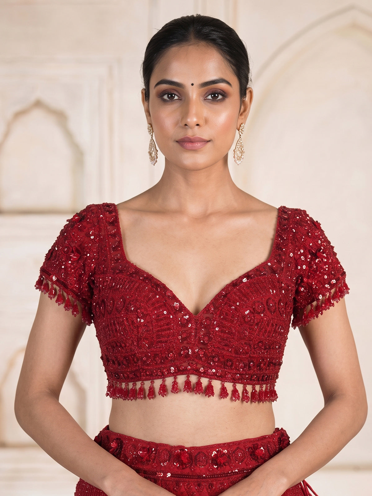 Maroon net designer lehenga choli with stone work tassel detailing