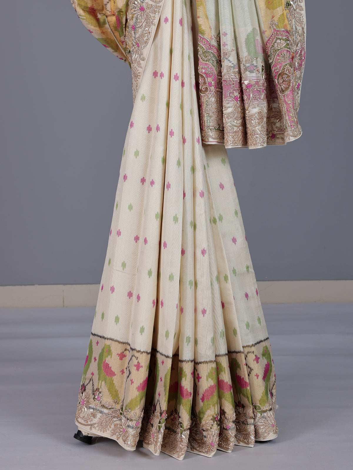 Cream patola silk saree with peacock motif contrast border and pallu