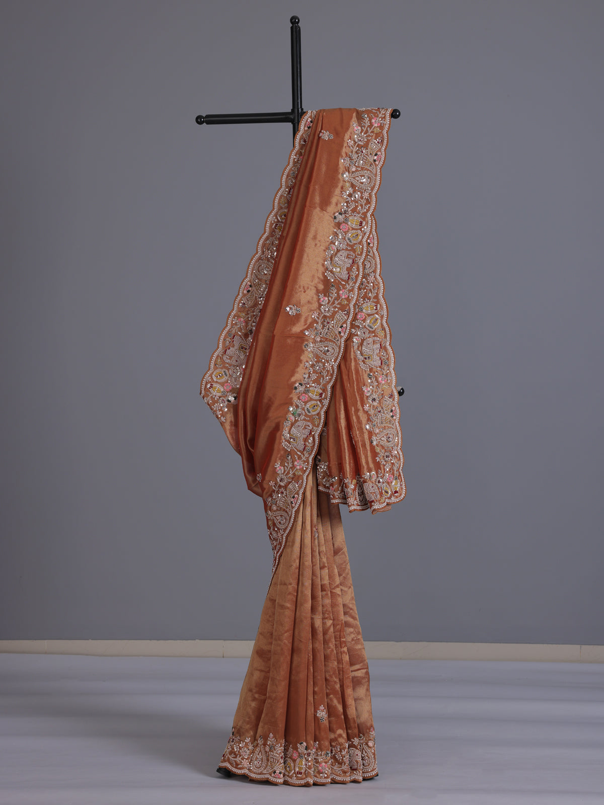 Pastel orange tissue silk saree with elephant border festive elegance