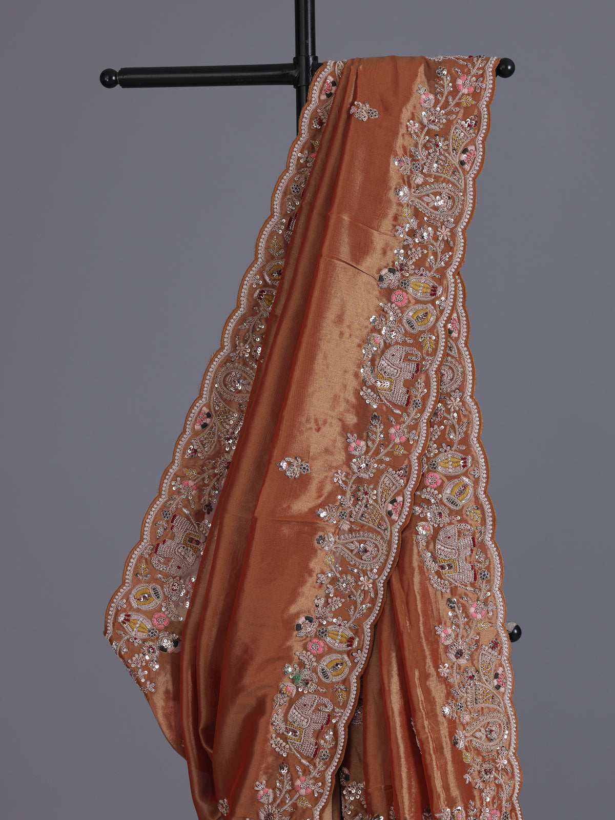 Pastel orange tissue silk saree with elephant border festive elegance