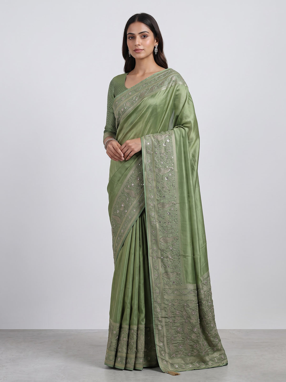 Pastel pista green shimmer dola silk saree with peacock motifs