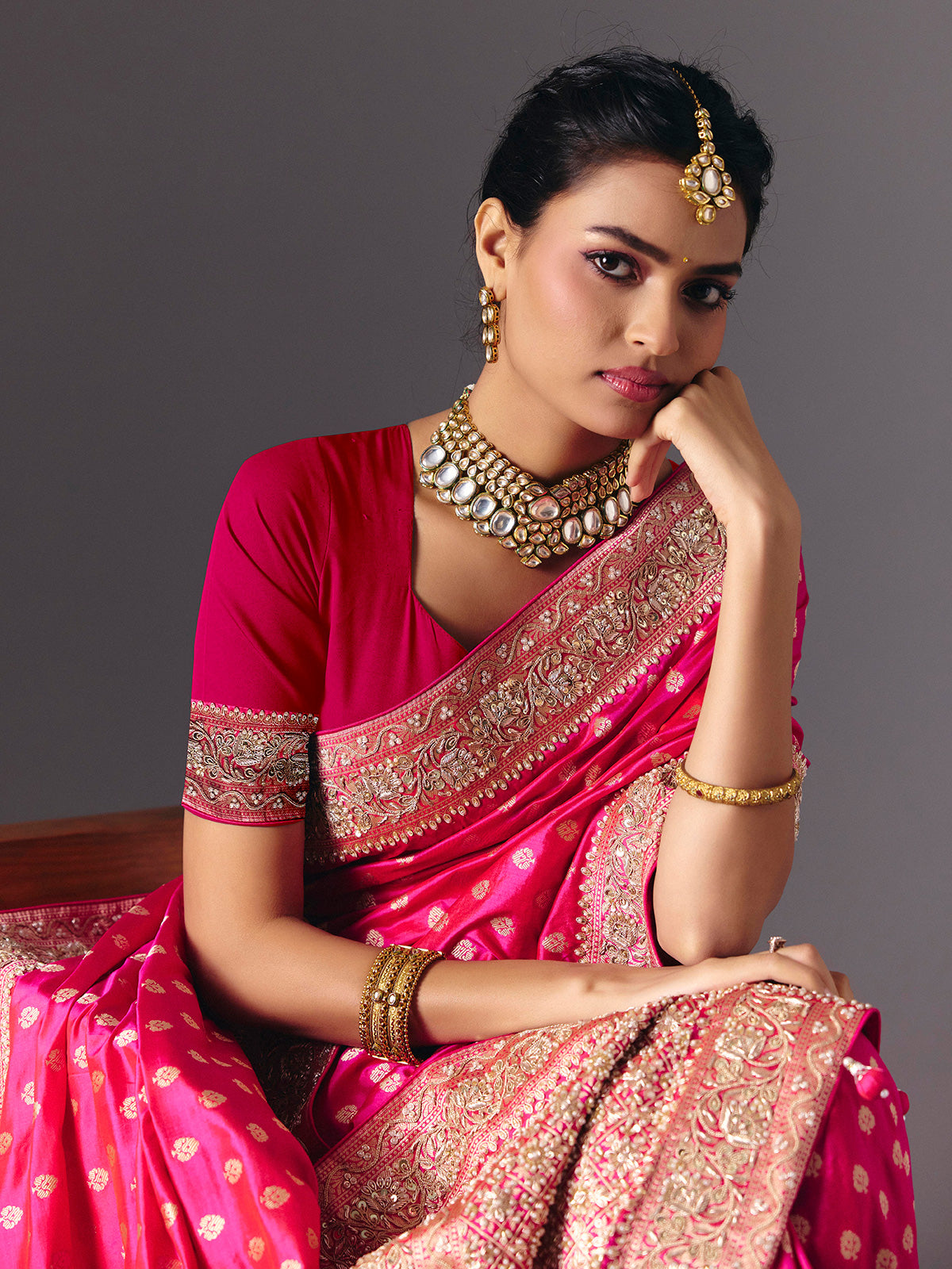 Rani pink banarasi silk saree with butti work and tassels