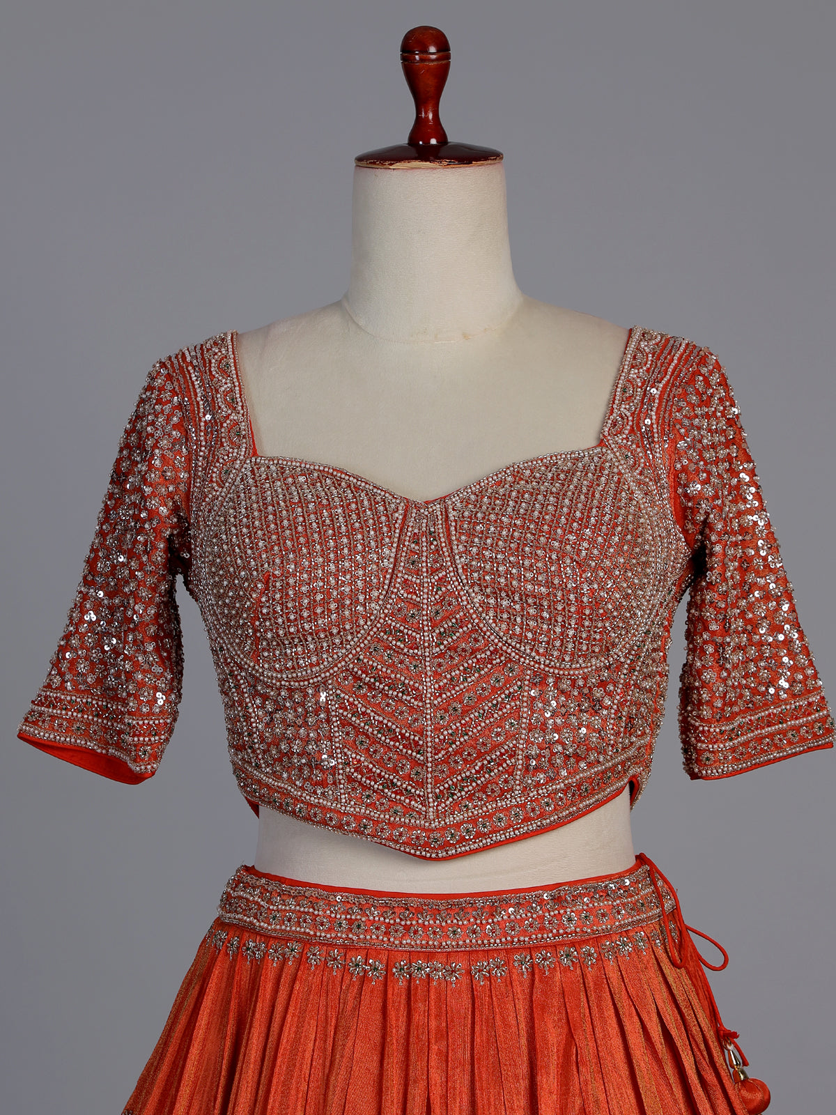 Rust orange silk embellished designer lehenga choli with tassel dupatta