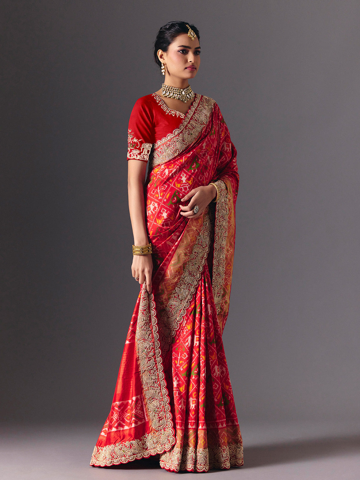 Red Hyderabadi patola silk saree with luxurious printed bridal artistry