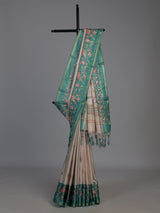 Beige and green art tusser silk saree with elegant bird motifs