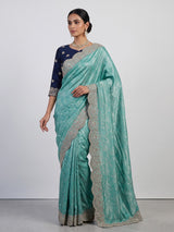 Pastel rama green tissue silk saree with elegant embellishments