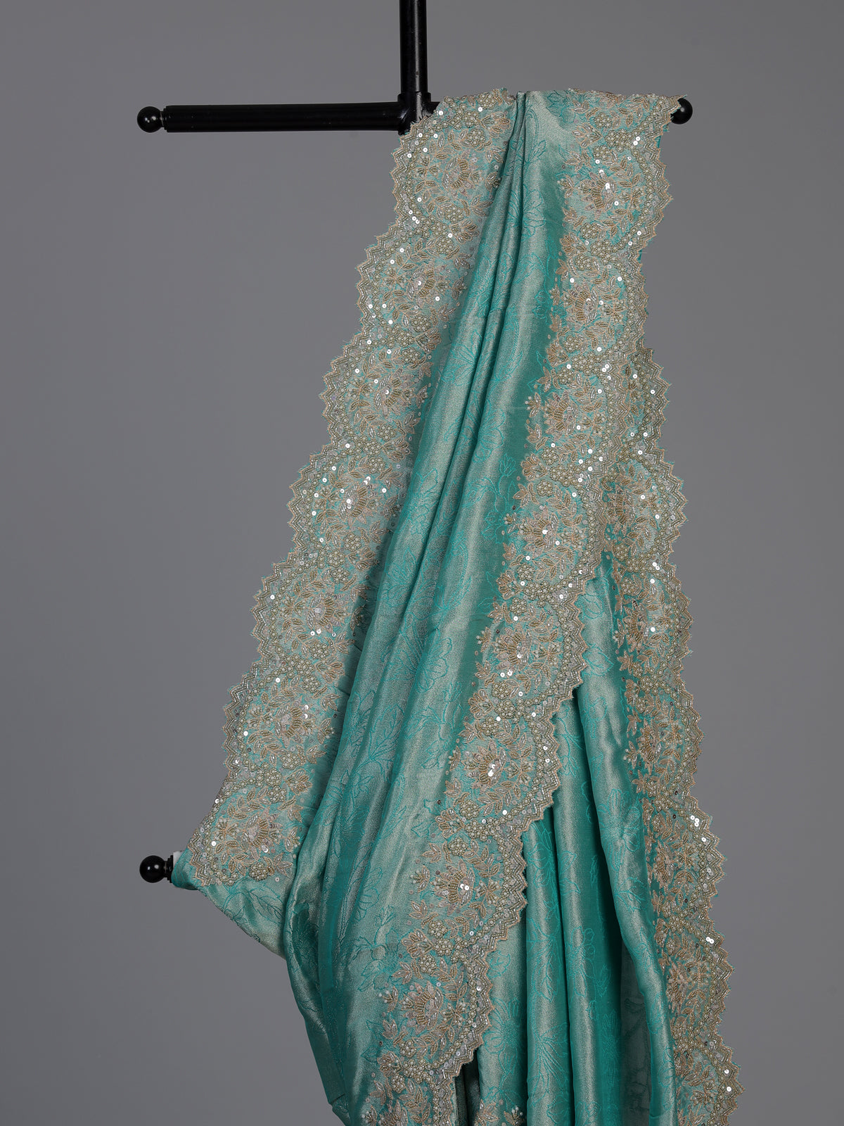 Pastel rama green tissue silk saree with elegant embellishments