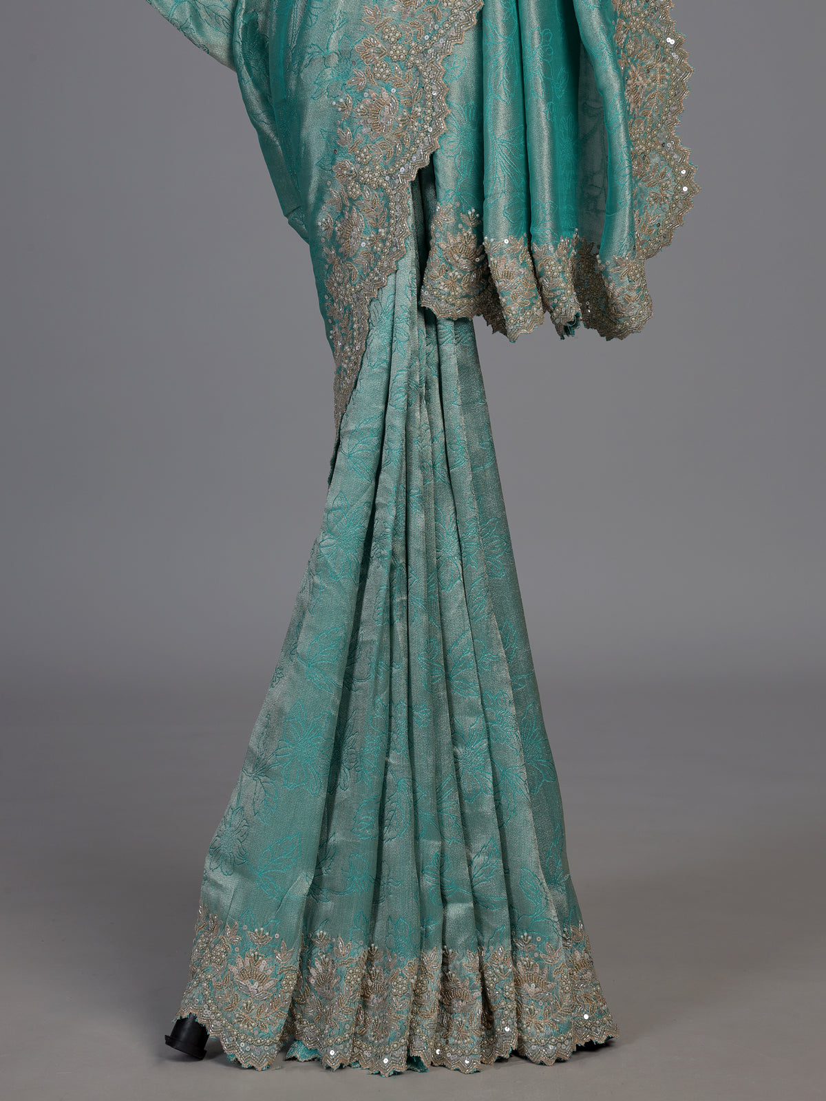 Pastel rama green tissue silk saree with elegant embellishments