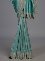 Pastel rama green tissue silk saree with elegant embellishments