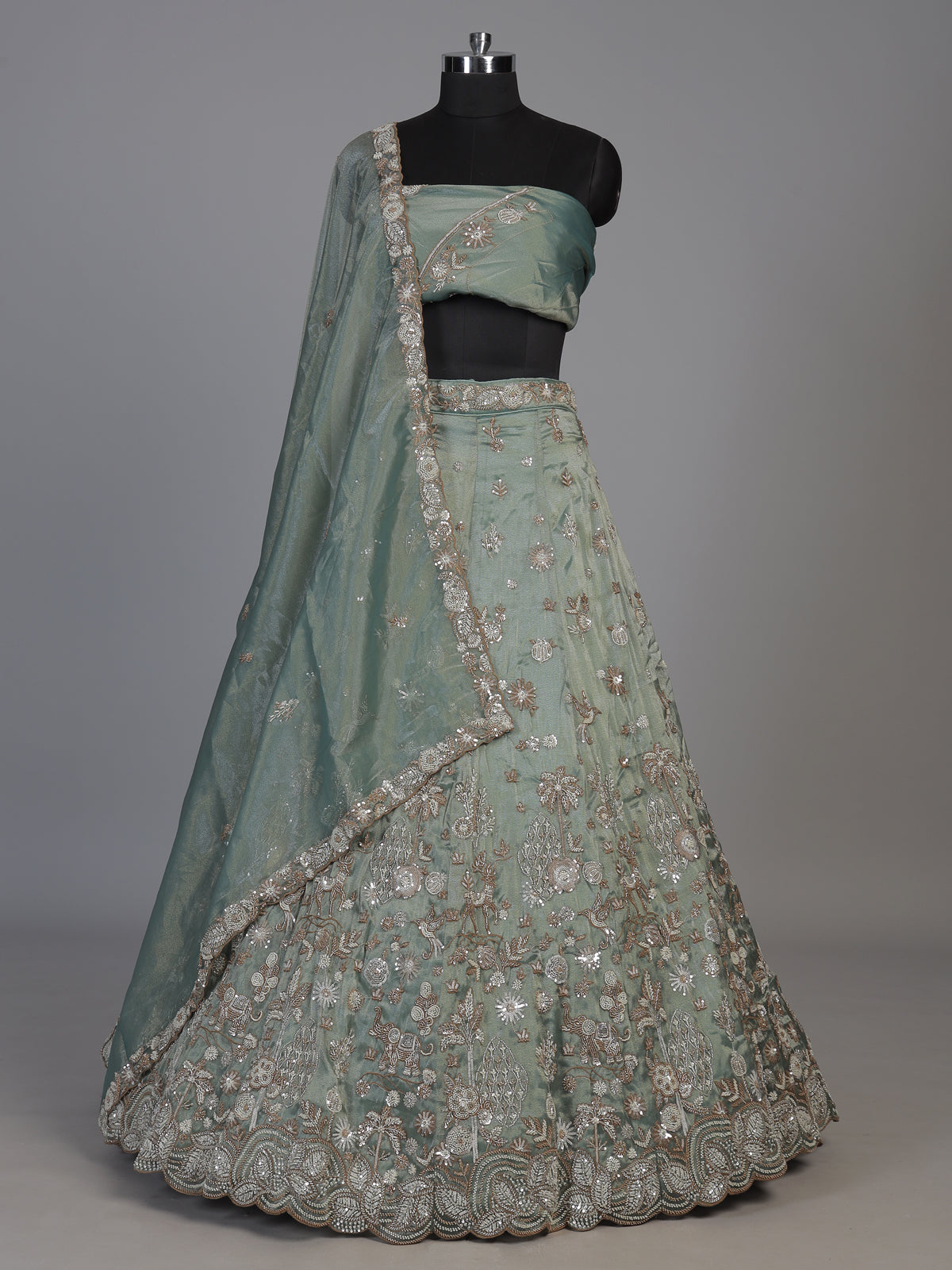 Pista green silk lehenga choli with elephant bird motifs