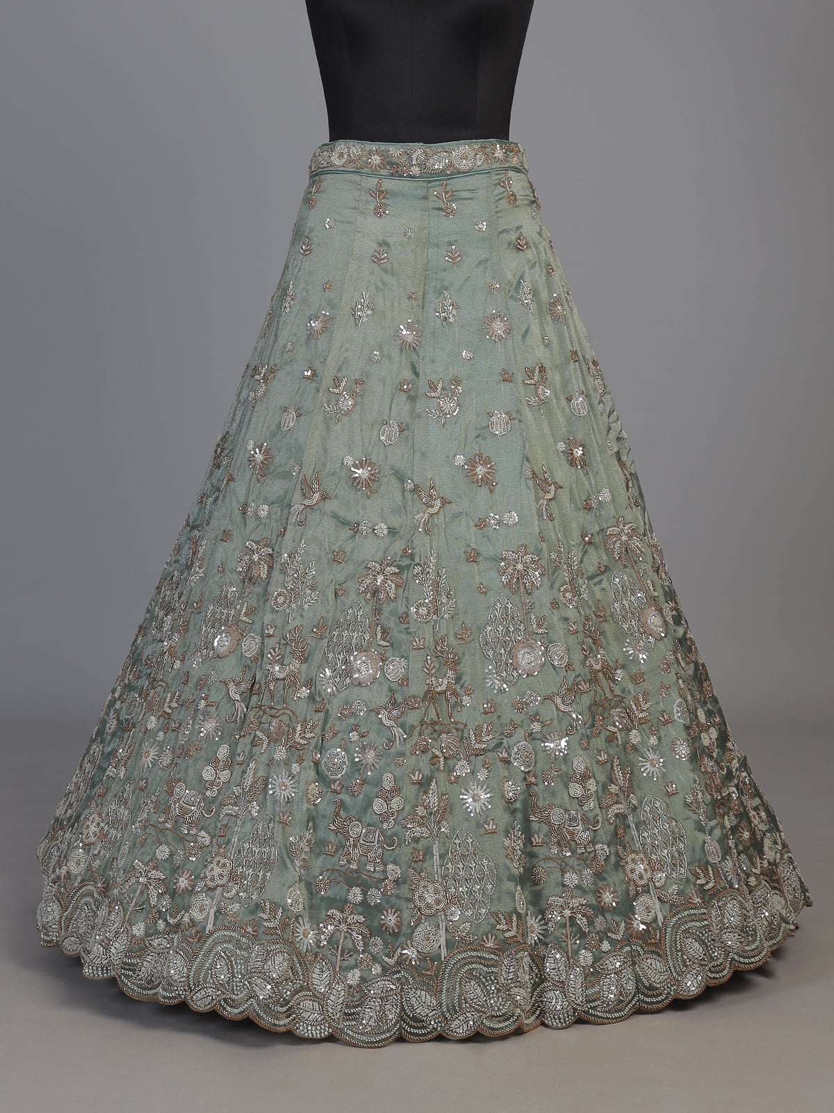 Pista green silk lehenga choli with elephant bird motifs