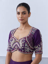 Royal purple silk lehenga choli with intricate festive craftsmanship