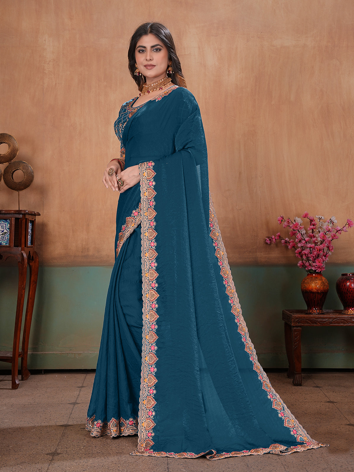 Peacock blue graceful embroidered satin festive saree