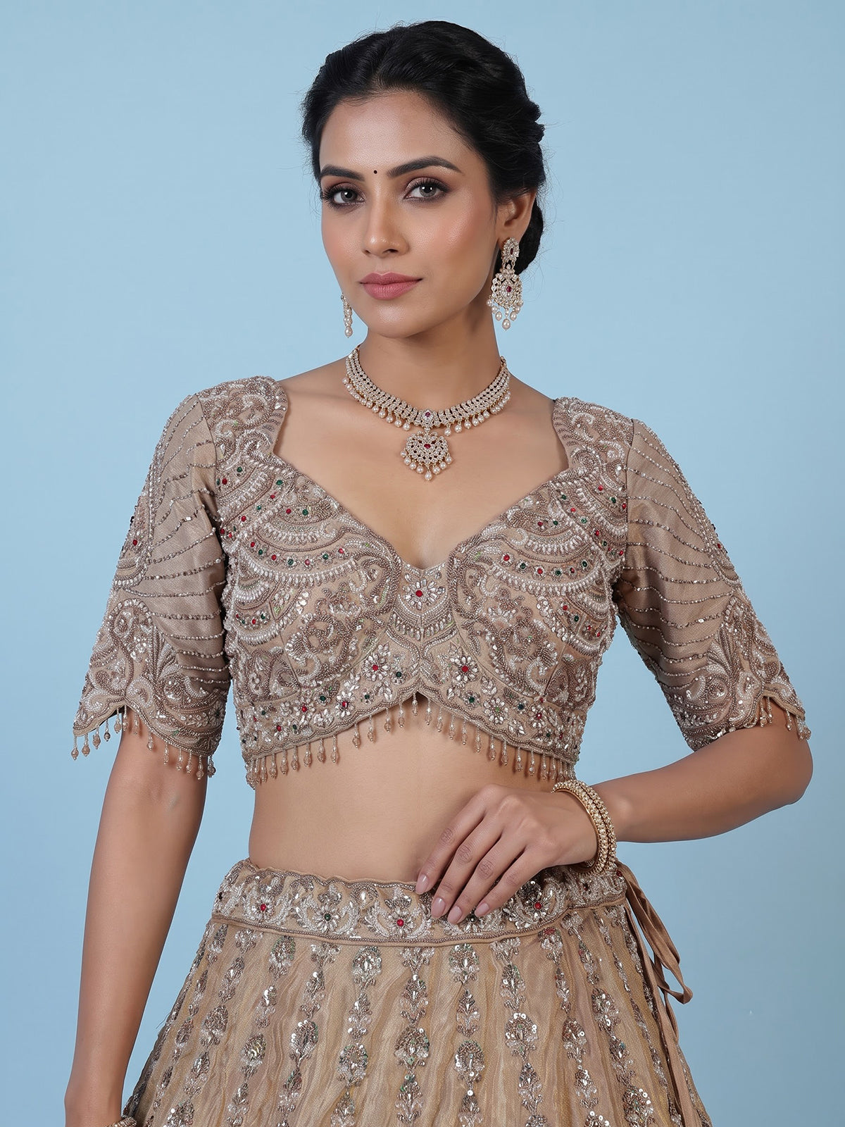 Beige silk lehenga choli with shimmering diamond stone embellishments