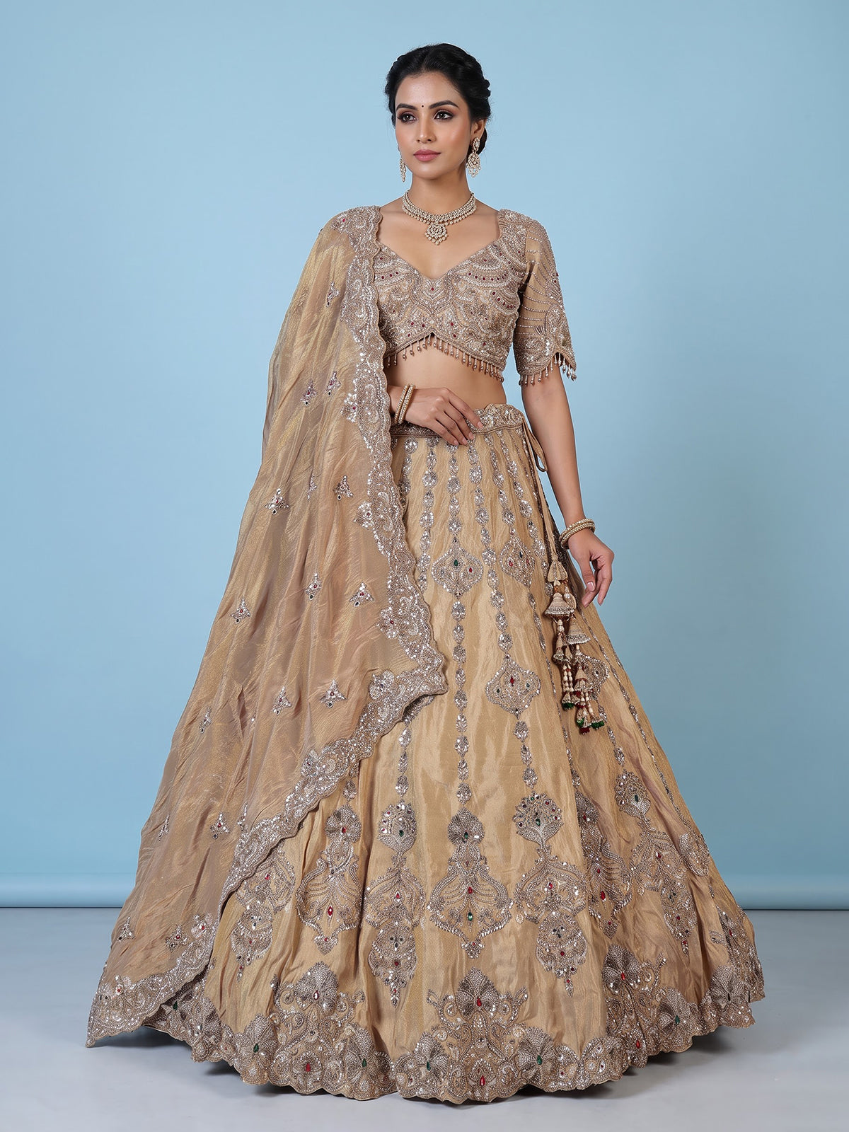 Beige silk lehenga choli with shimmering diamond stone embellishments