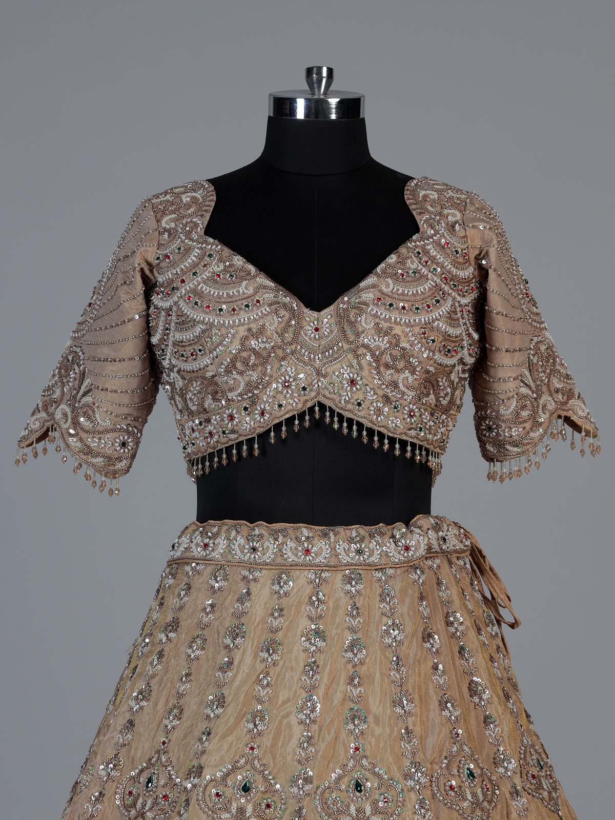 Beige silk lehenga choli with shimmering diamond stone embellishments