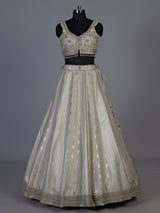 Cream jacquard brocade lehenga choli with lavish embellishments