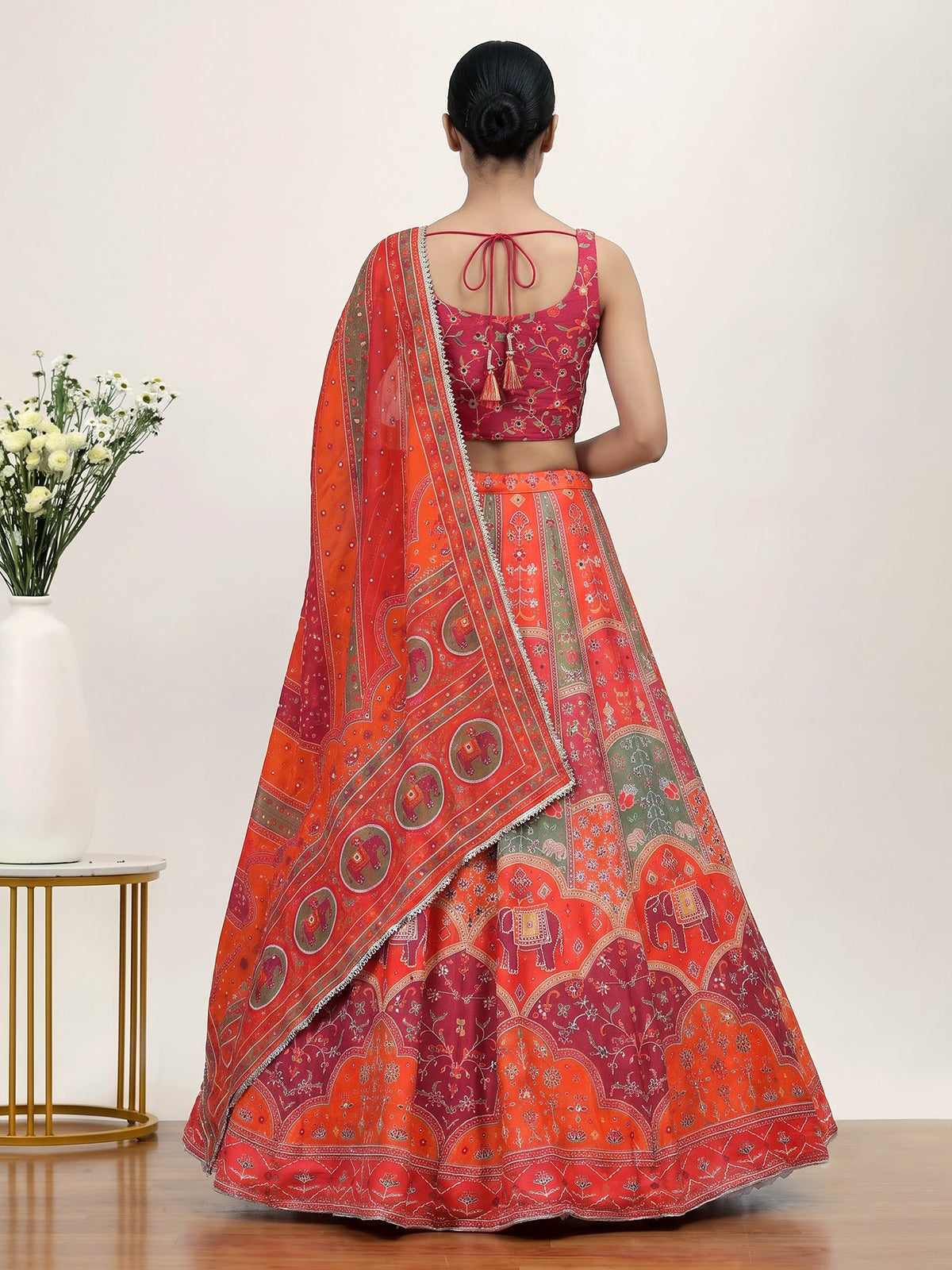 Orange art silk lehenga choli with elephant motif embellishments