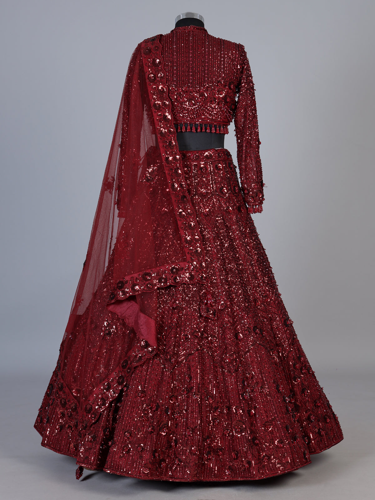 Maroon net lehenga choli with luxurious pearl cutdana embellishments