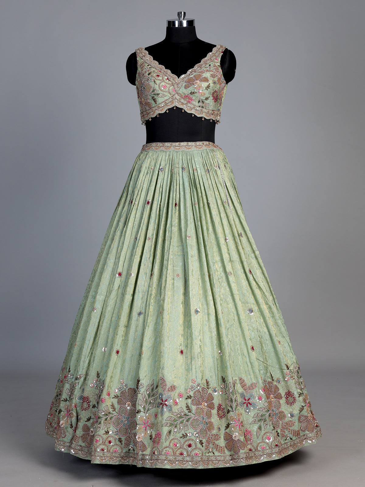 Pista green silk lehenga with zardosi festive detailing
