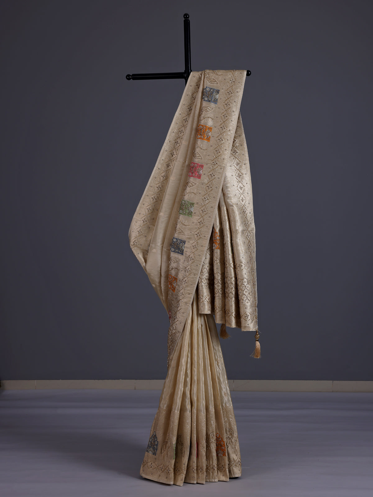 Pastel beige silk saree with delicate traditional embellishments