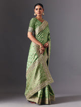 Pista green satin silk saree with ornate animal motif detailing