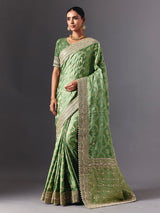 Pista green satin silk saree with ornate animal motif detailing