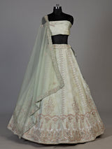 Mint green silk unstitched lehenga choli with intricate zari elegance