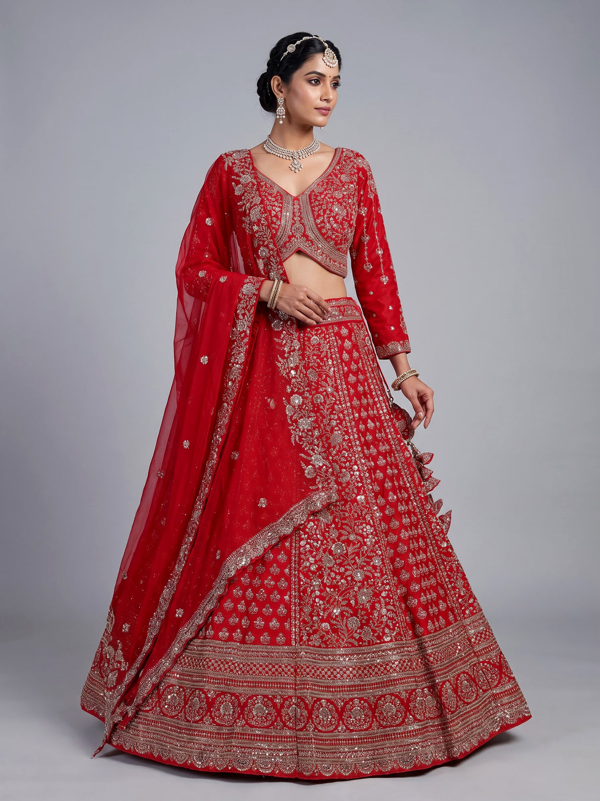 Red silk lehenga choli with exquisite resham and cutdana detailing