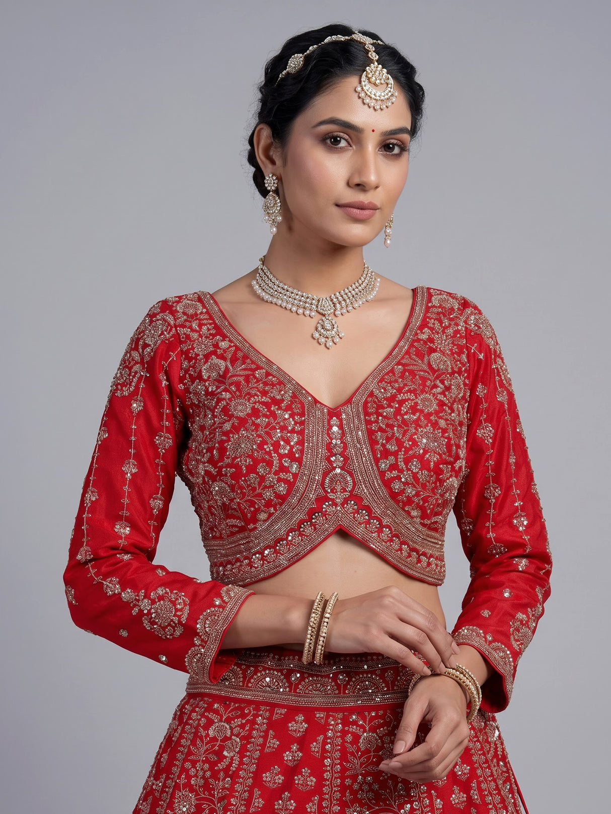 Red silk lehenga choli with exquisite resham and cutdana detailing