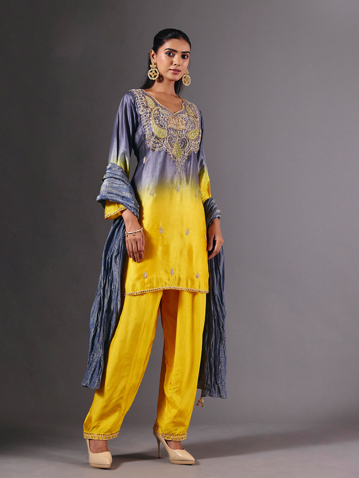 Yellow silk shaded salwar suit with purple dupatta and embellishments