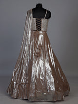 Sophisticated beige shimmer tissue silk lehenga choli with tassel accents