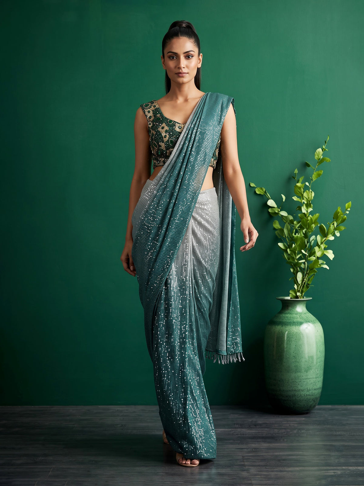 Green shaded sequin fabric saree with embellished tassel pallu