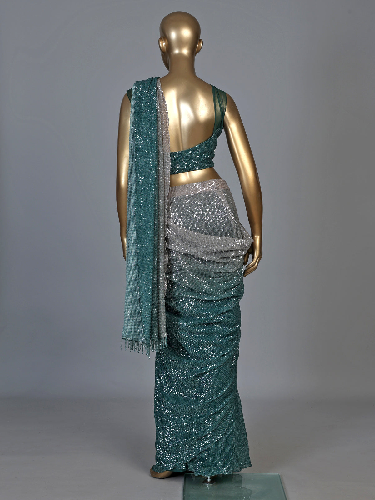 Green shaded sequin fabric saree with embellished tassel pallu
