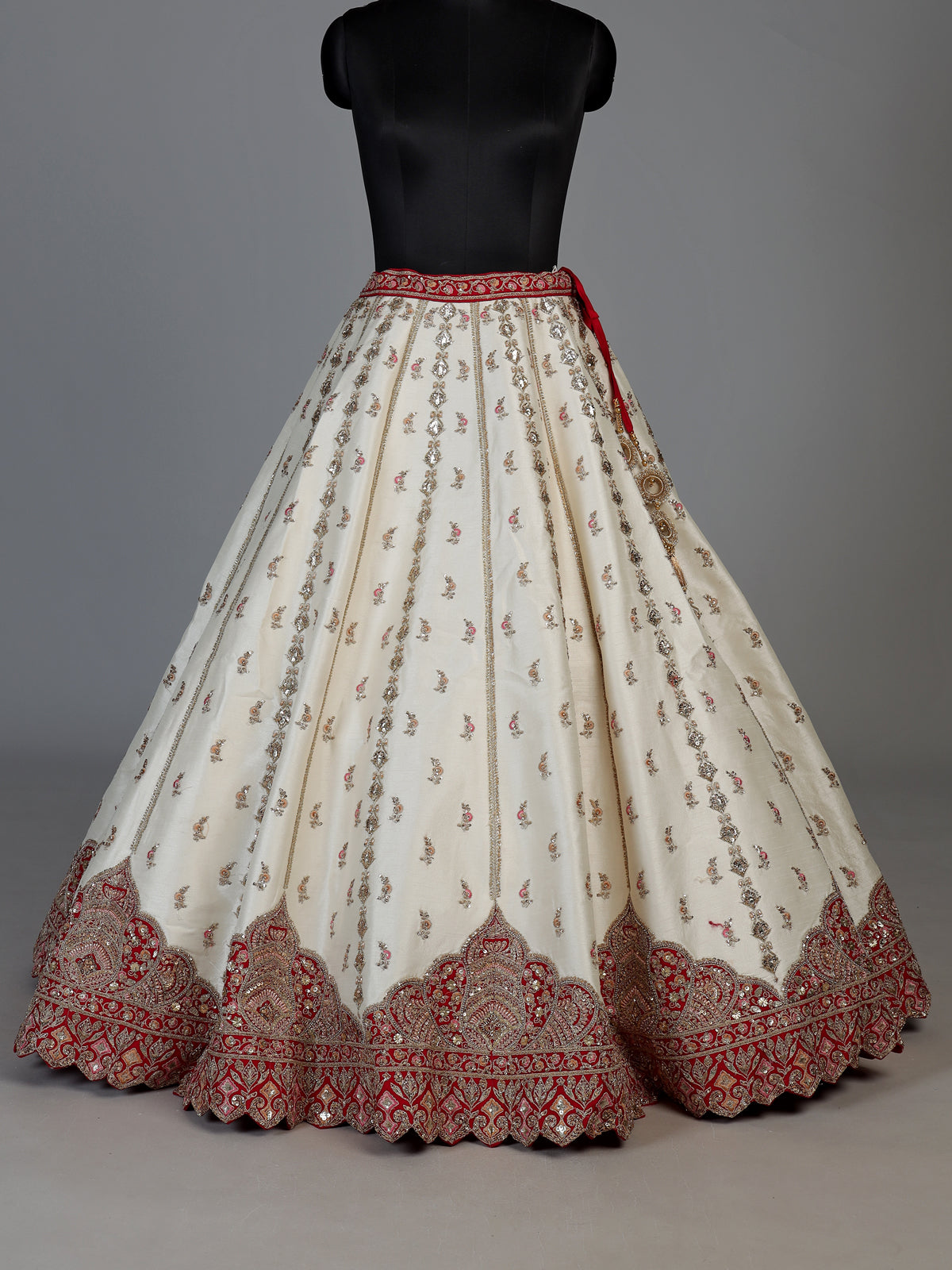 Cream and red bridal lehenga choli with jharokha work